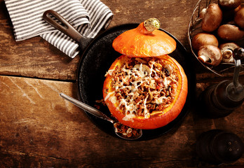 Tasty autumn stuffed pumpkin with mushrooms - obrazy, fototapety, plakaty