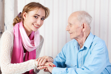 Senior man with her caregiver at home