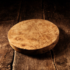 Old round rustic wooden cheese board