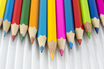 Colorful pencils on white cardboard