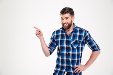 Portrait of a smiling man pointing finger away