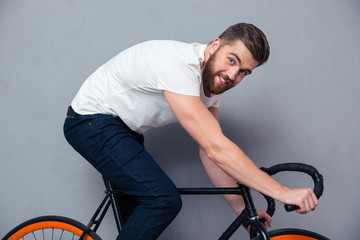 Fototapeta na wymiar Portrait of a smiling man riding on bicycle