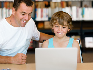 Little boy and his father with laptop