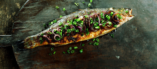 Whole Roasted Fish Garnished with Onions