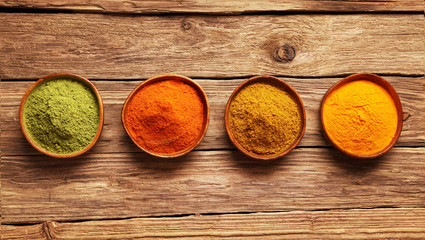 Row of colorful spices in bowls
