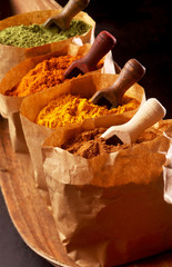 Brown paper packets filled with ground spices