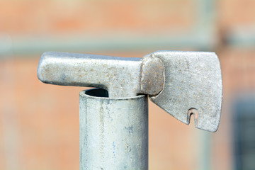 Roofers tiling hammer in end of scaffolding pole
