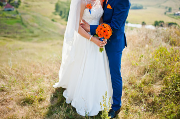 wedding couple with bouquet at hand background landskape