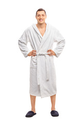 Cheerful young man in a white bathrobe