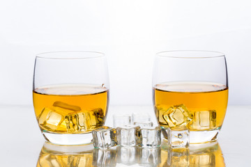 Whiskey with ice cubes in glass