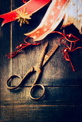Christmas decoration with aged scissors on dark wooden background