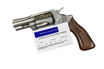 Gun with Concealed Weapon Permit Isolated on White