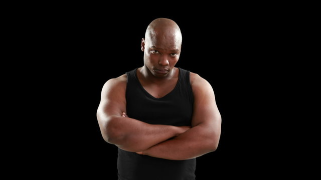 Muscular man with arms crossed looking at camera 