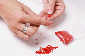 Stringing beads on a needle
Нанизывание бисера на иголку - obrazy, fototapety, plakaty