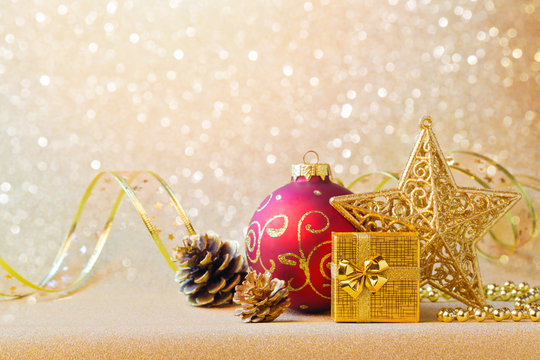 Christmas decorations in red and gold over glitter sparkle background