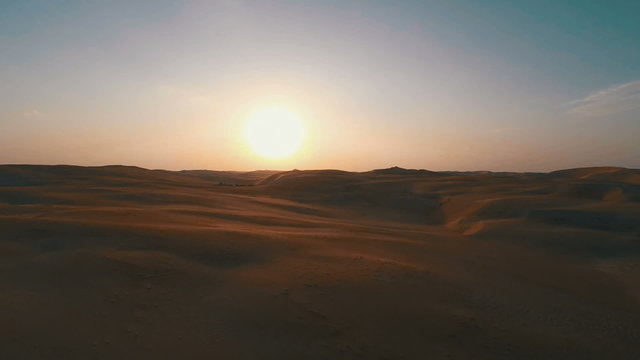 Dusk in the desert flying backwards over barren land