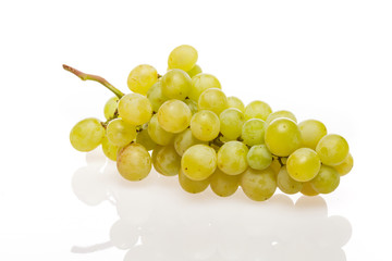 Fresh grape cluster on white with water drops