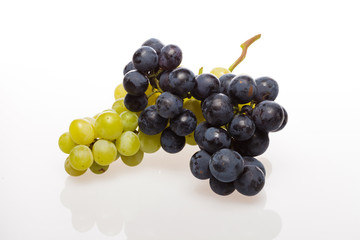 Fresh grape cluster on white with water drops