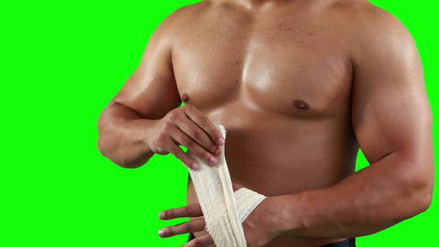 Serious muscular man wearing bandage 