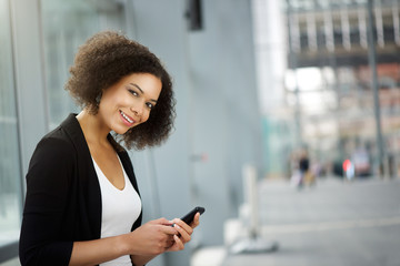 Business woman smiling with cellphone