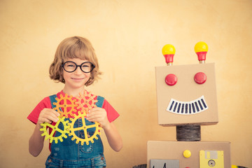 Funny nerd child with toy robot