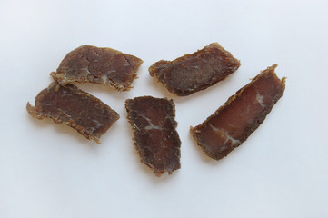 Biltong snack piled up on white paper