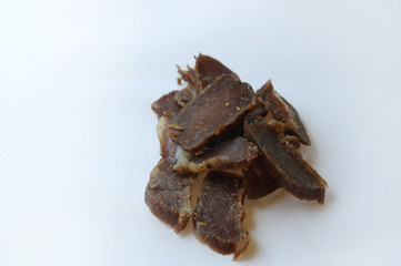 Biltong snack piled up on white paper