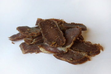 Biltong snack piled up on white paper