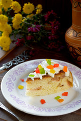 Celebration cake with vanilla sause, decorated candied fruits
