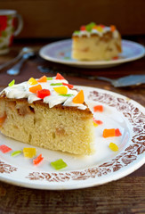 Celebration cake with vanilla sause, decorated candied fruits