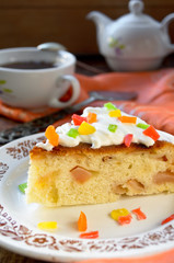 Celebration cake with vanilla sause, decorated candied fruits
