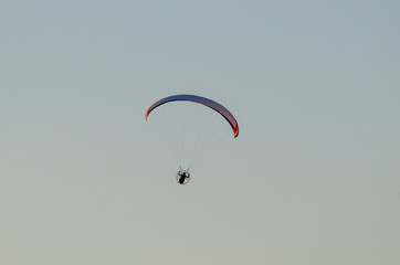 Paraglider in the sky at sunset