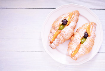 Fresh fruit croissant on white background