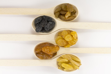 Colorful raisins in a wooden spoon