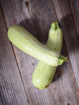 Fresh zucchinis on wood background