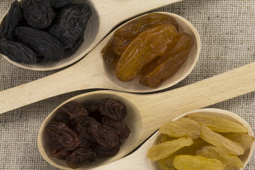 Colorful raisins in a wooden spoon