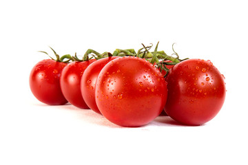 Bunch of fresh tomatoes with water drops. Isolated
