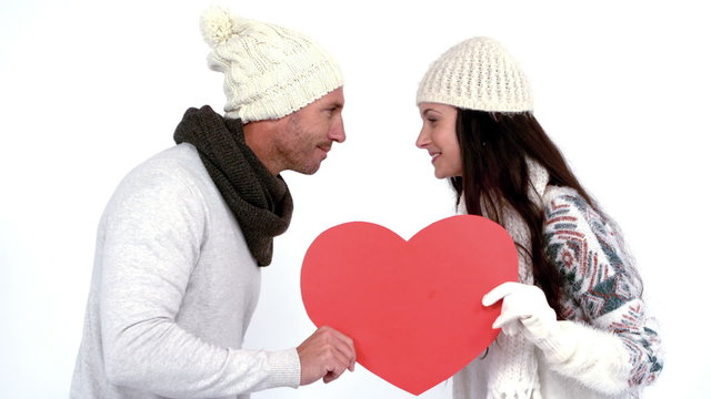 Winter couple holding heart card