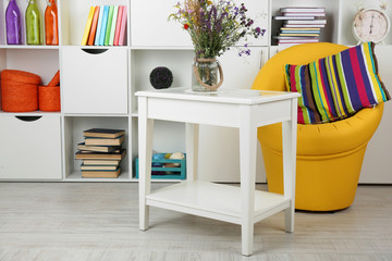 White living room with armchair and bookcase
