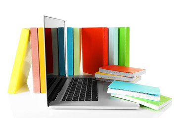 Stack of books with laptop isolated on white