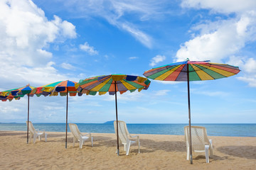 Beach chair and umbrella on sand beach