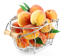 Ripe peaches in basket isolated on white