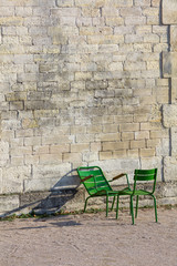 Stone wall and two green chairs in Tuileries Garden (Vertical) - 92883369