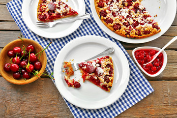 Tasty homemade pie with cherries on table close up