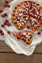 Tasty homemade pie with cherries on table close up