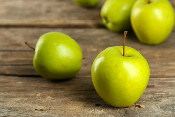 Ripe green apples on wooden table close up