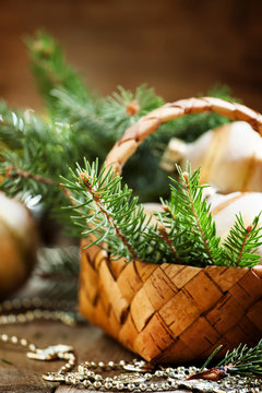 Christmas golden Christmas balls in a wicker basket with fir bra