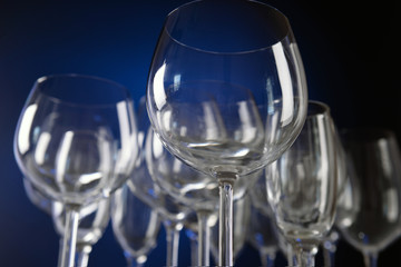 Empty wine glasses on blue background