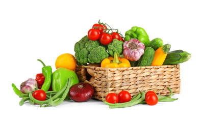 Heap of fresh fruits and vegetables  in basket isolated on white