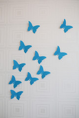Blue paper butterfly on the wall
